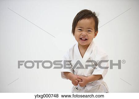 Japanese kid in karate uniform training View Large Photo Image Stock Photo - Japanese kid in karate uniform training. Fotosearch