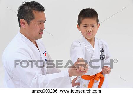 Japanese kid in karate uniform training with teacher on white background View Large Photo Image Stock Photograph - Japanese kid in karate uniform training with teacher on white background. Fotosearch