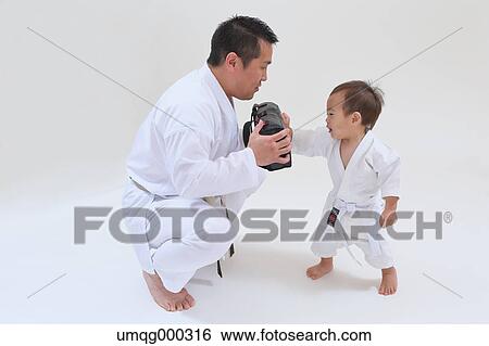 Japanese kid in karate uniform training with teacher on white background View Large Photo Image Stock Photograph - Japanese kid in karate uniform training with teacher on white background. Fotosearch