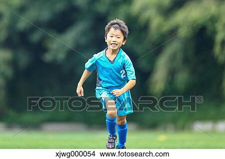 Japanese kid playing soccer View Large Photo Image Picture - Japanese kid playing soccer. Fotosearch