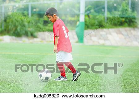 Japanese kid playing soccer View Large Photo Image Stock Image - Japanese kid playing soccer. Fotosearch