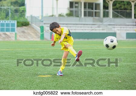 Japanese kid playing soccer View Large Photo Image Stock Image - Japanese kid playing soccer. Fotosearch