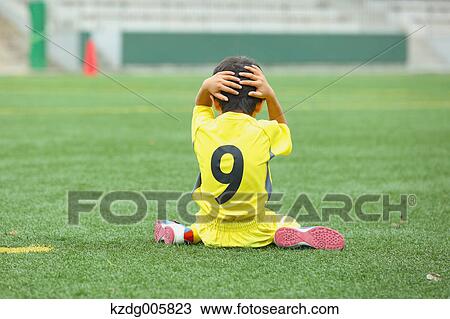 Stock Image - Japanese kid playing soccer. Fotosearch