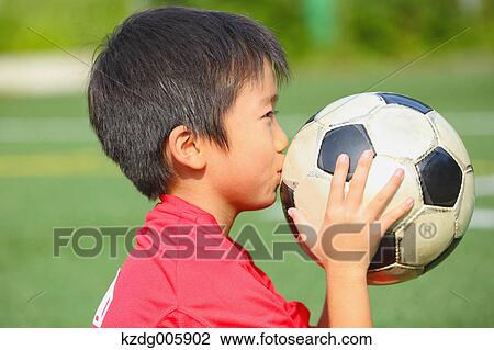 Japanese kid playing soccer View Large Photo Image Stock Image - Japanese kid playing soccer. Fotosearch