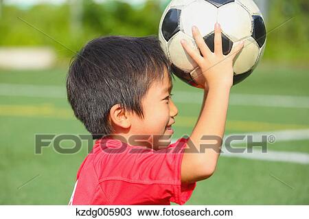 Japanese kid playing soccer View Large Photo Image Stock Image - Japanese kid playing soccer. Fotosearch