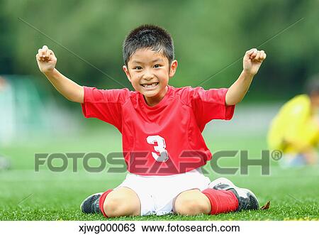 Stock Image - Japanese kid playing soccer. Fotosearch