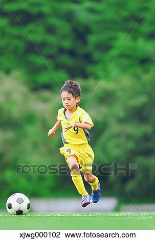 Japanese kid playing soccer View Large Photo Image Stock Image - Japanese kid playing soccer. Fotosearch