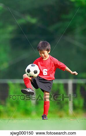 Japanese kid playing soccer View Large Photo Image Stock Image - Japanese kid playing soccer. Fotosearch