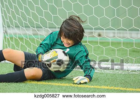 Stock Photo - Japanese kid playing soccer. Fotosearch