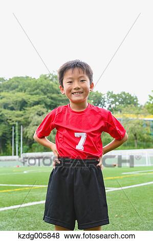 Stock Photo - Japanese kid playing soccer. Fotosearch