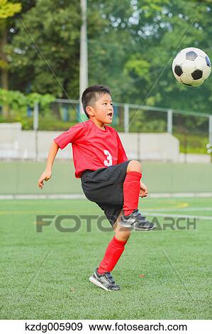 Japanese kid playing soccer View Large Photo Image Stock Photo - Japanese kid playing soccer. Fotosearch