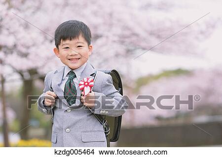Japanese kid with cherry blossoms in a city park View Large Photo Image Picture - Japanese kid with cherry blossoms in a city park. Fotosearch