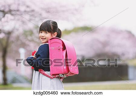 Japanese kid with cherry blossoms in a city park View Large Photo Image Stock Image - Japanese kid with cherry blossoms in a city park. Fotosearch