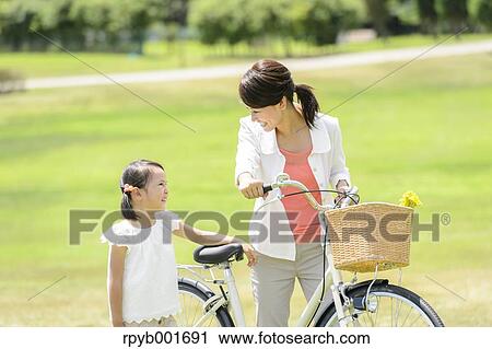 Japanese kid with mother at the park View Large Photo Image Stock Image - Japanese kid with mother at the park. Fotosearch