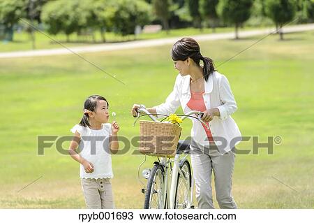 Japanese kid with mother at the park View Large Photo Image Stock Image - Japanese kid with mother at the park. Fotosearch
