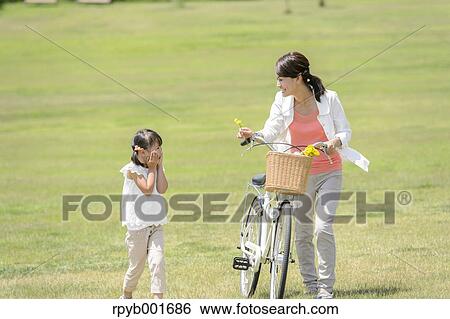 Japanese kid with mother at the park View Large Photo Image Stock Photograph - Japanese kid with mother at the park. Fotosearch