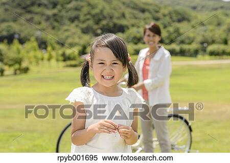 Stock Photography - Japanese kid with mother at the park. Fotosearch