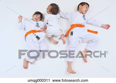 Stock Image - Japanese kids in karate uniform on white background. Fotosearch