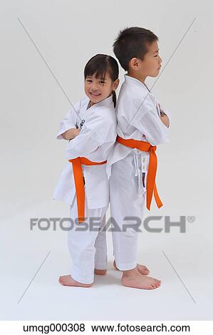 Stock Photo - Japanese kids in karate uniform on white background. Fotosearch