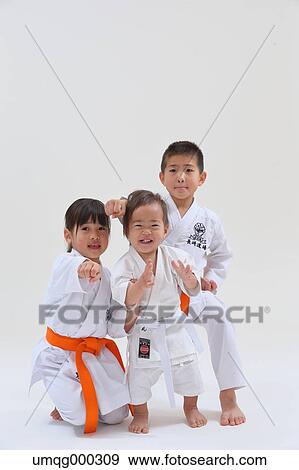 Stock Photo - Japanese kids in karate uniform on white background. Fotosearch