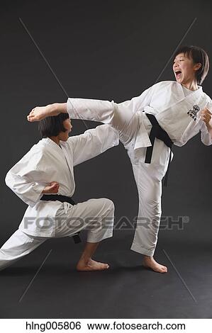 Stock Photograph - Japanese kids in karate uniform on black background. Fotosearch