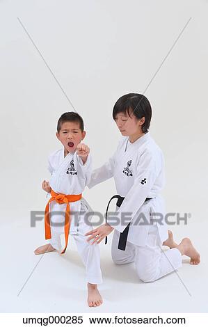 Stock Photography - Japanese kids in karate uniform on white background. Fotosearch