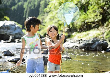 Japanese kids playing at the river View Large Photo Image Stock Photo - Japanese kids playing at the river. Fotosearch