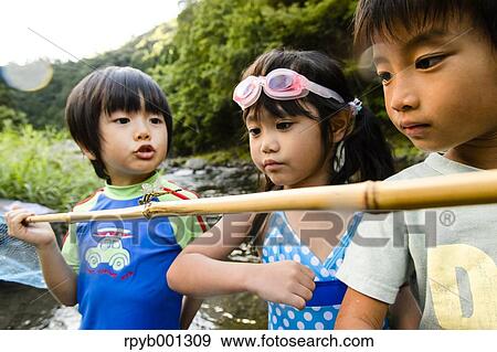 Japanese kids playing at the river View Large Photo Image Stock Photo - Japanese kids playing at the river. Fotosearch