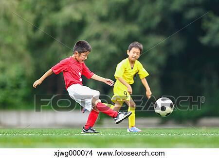 Japanese kids playing soccer View Large Photo Image Picture - Japanese kids playing soccer. Fotosearch