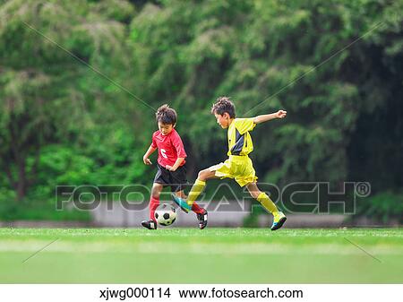 Japanese kids playing soccer View Large Photo Image Picture - Japanese kids playing soccer. Fotosearch