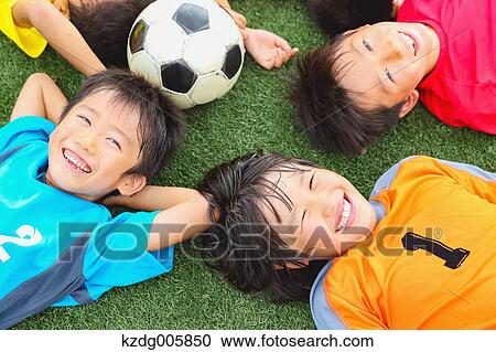 Stock Image - Japanese kids playing soccer. Fotosearch