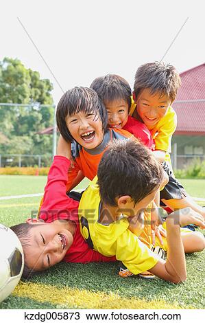 Stock Image - Japanese kids playing soccer. Fotosearch