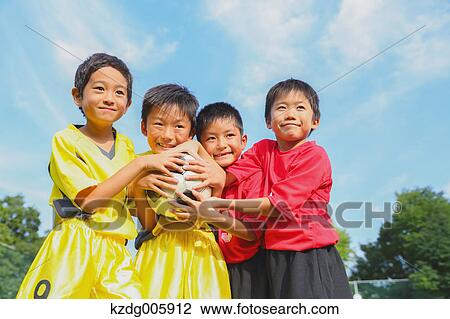 Stock Image - Japanese kids playing soccer. Fotosearch