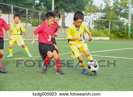 Stock Image - Japanese kids playing soccer. Fotosearch