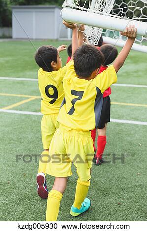 Stock Image - Japanese kids playing soccer. Fotosearch