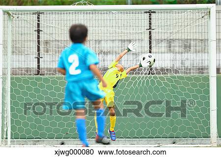 Stock Image - Japanese kids playing soccer. Fotosearch