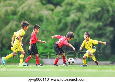 Stock Image - Japanese kids playing soccer. Fotosearch
