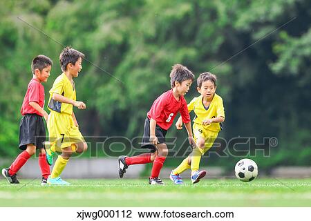 Stock Image - Japanese kids playing soccer. Fotosearch