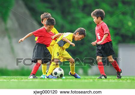 Stock Image - Japanese kids playing soccer. Fotosearch