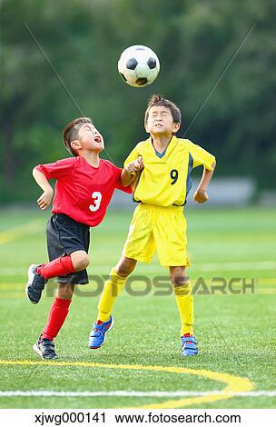 Stock Image - Japanese kids playing soccer. Fotosearch