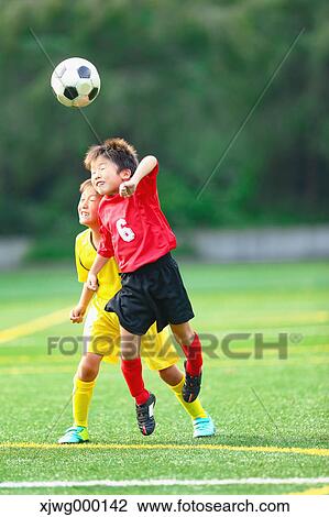 Stock Image - Japanese kids playing soccer. Fotosearch
