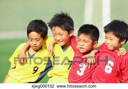 Stock Image - Japanese kids playing soccer. Fotosearch