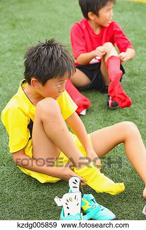 Stock Photo - Japanese kids playing soccer. Fotosearch