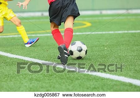 Stock Photo - Japanese kids playing soccer. Fotosearch