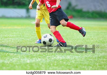 Stock Photo - Japanese kids playing soccer. Fotosearch