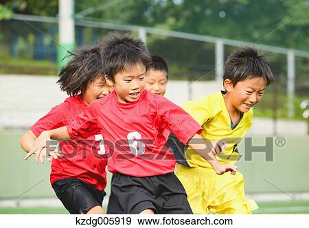 Stock Photo - Japanese kids playing soccer. Fotosearch