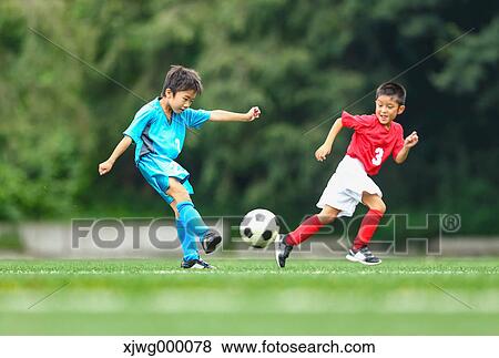 Stock Photo - Japanese kids playing soccer. Fotosearch