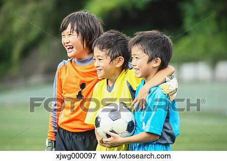 Stock Photo - Japanese kids playing soccer. Fotosearch