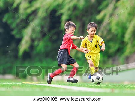 Japanese kids playing soccer View Large Photo Image Stock Photo - Japanese kids playing soccer. Fotosearch