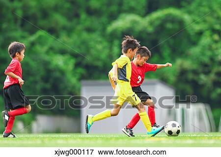 Stock Photo - Japanese kids playing soccer. Fotosearch